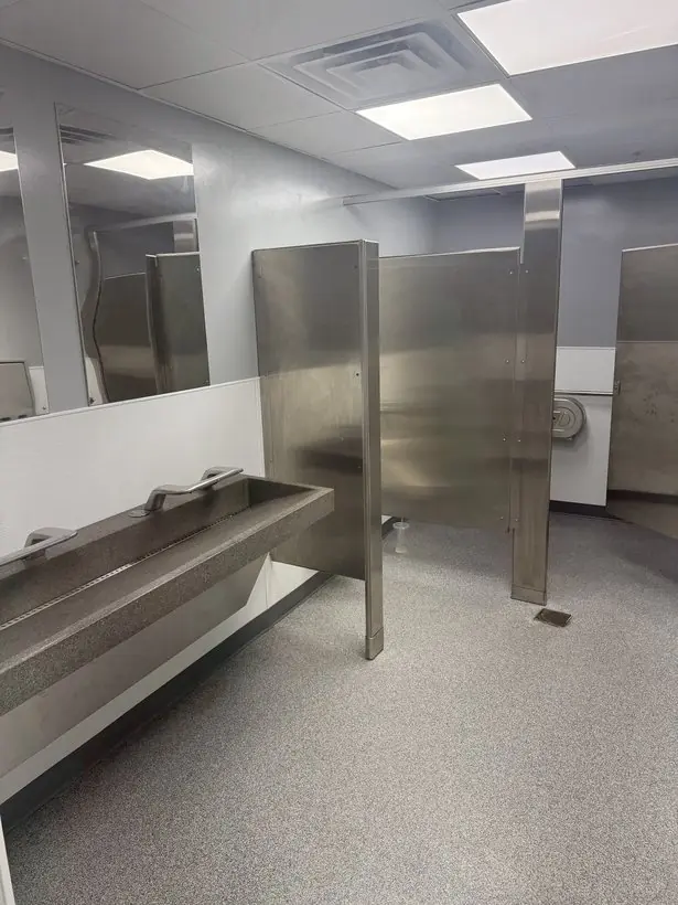 Restroom floor — coated under partitions and around floor drains — epoxy flake flooring by Vibrant Painting, Greenville SC