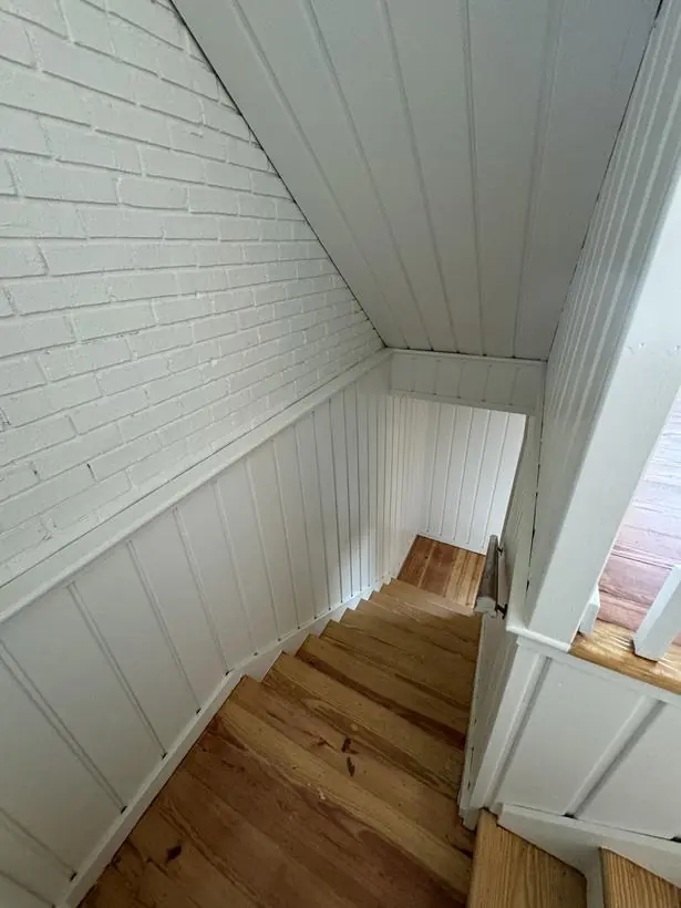 Upper landing — beadboard, brick, and trim — lakefront home repaint by Vibrant Painting, Greenville SC