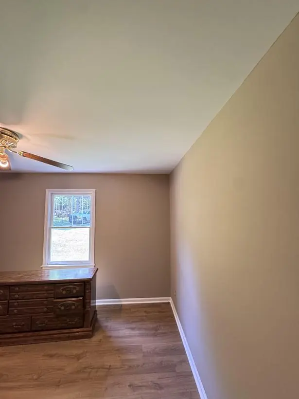Bedroom corner — clean ceiling line edge to edge — interior repaint by Vibrant Painting, Greenville SC